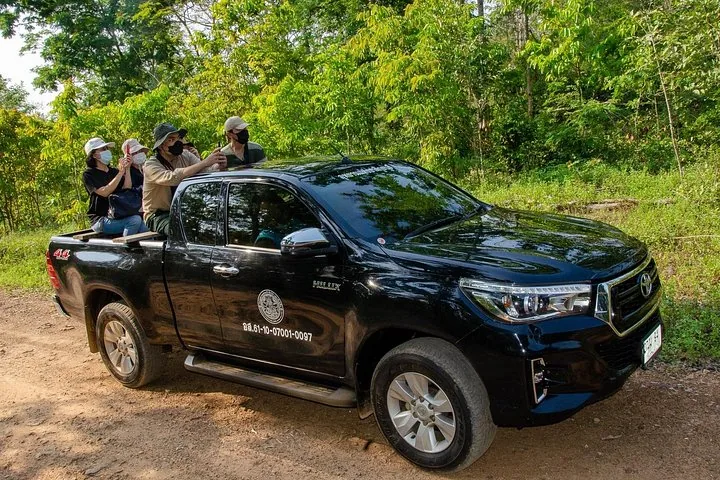 Des touristes à l'arrière d'un pick-up lors d'un safari guidé.